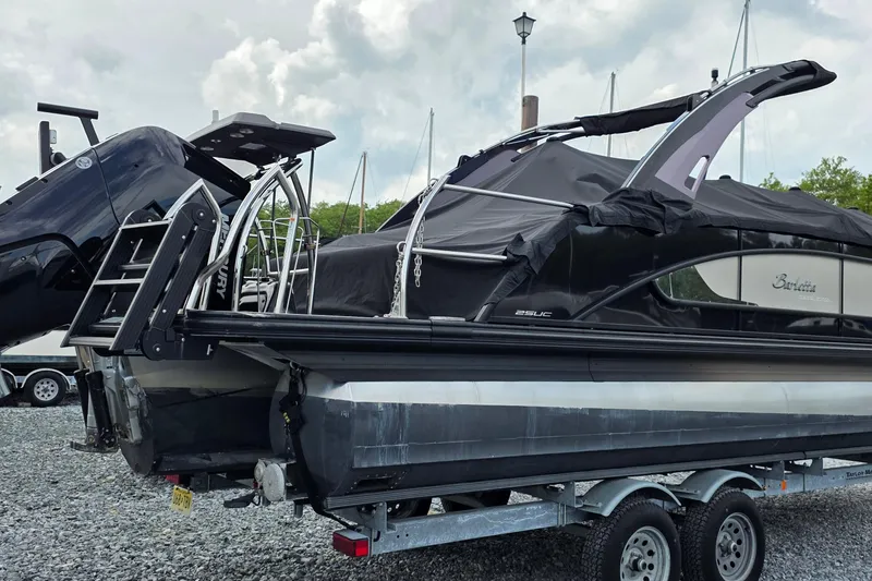 Slide: The Image of 2025 Barletta Lusso 25UCA pontoon boat on trailer, covered and ready for transport. - 2