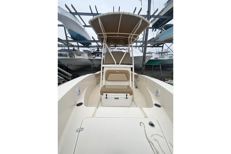 Slide: The Image of 2020 Scout 195 Sportfish boat with seating and canopy in storage. - 9