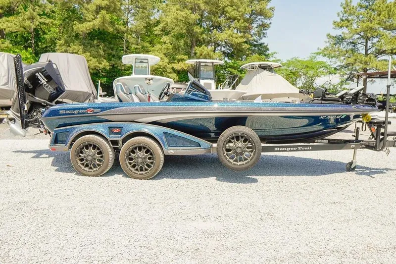 The Image of 2025 Ranger Z520 boat on trailer, parked outdoors with trees in background. - 1