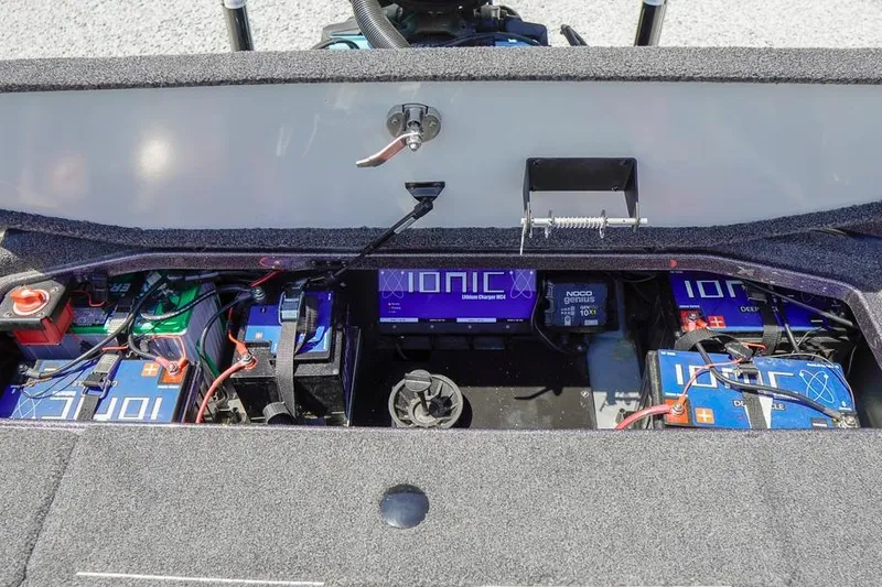 Slide: The Image of 2025 Ranger Z520 boat battery compartment with Ionic lithium batteries and charger. - 12