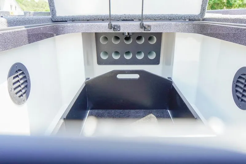 Slide: The Image of 2025 Ranger Z520 boat storage compartment with ventilation and rod holders. - 21