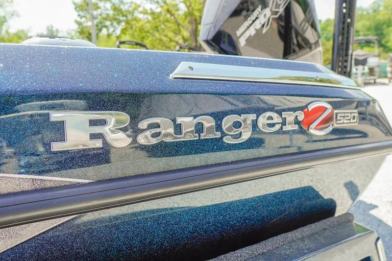 Slide: The Image of 2025 Ranger Z520 boat logo with metallic finish in outdoor setting. - 5