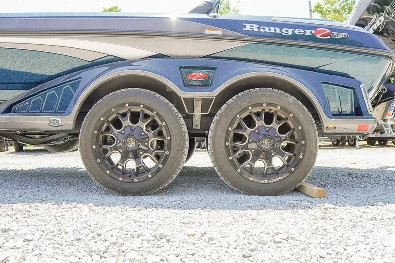 Slide: The Image of 2025 Ranger Z520 boat trailer with stylish black alloy wheels on gravel. - 6