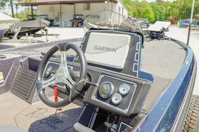 Slide: The Image of 2025 Ranger Z520 boat dashboard with Garmin navigation system and steering wheel. - 8
