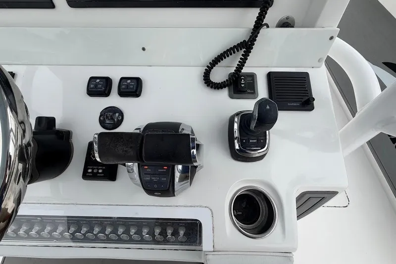 Slide: The Image of Control panel of a 2019 Invincible 40 Catamaran with steering and navigation controls. - 13