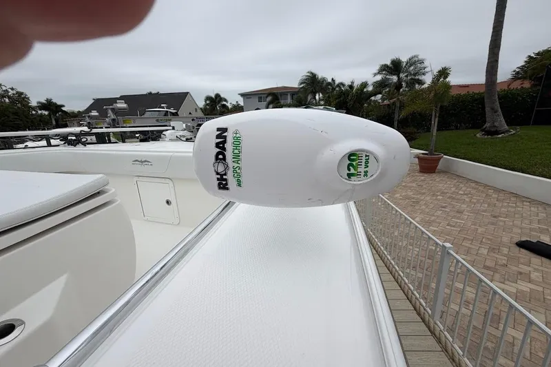 Slide: The Image of 2019 Invincible 40 Catamaran with Rhodan GPS Anchor system, docked near palm trees. - 15