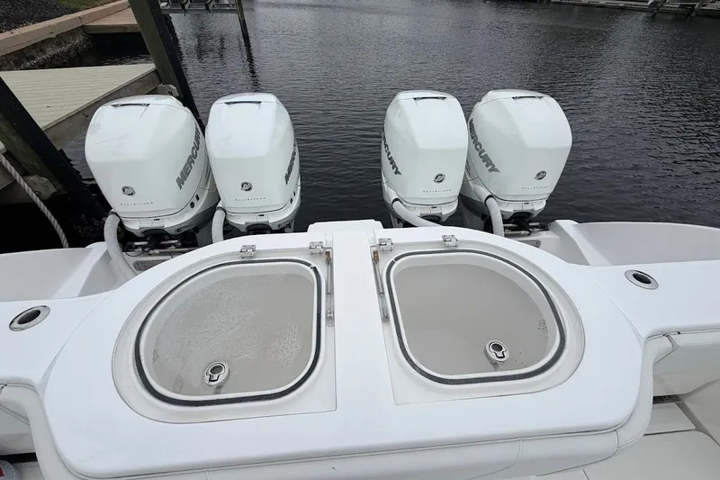 Slide: The Image of 2019 Invincible 40 Catamaran with four Mercury outboard engines at dock. - 21