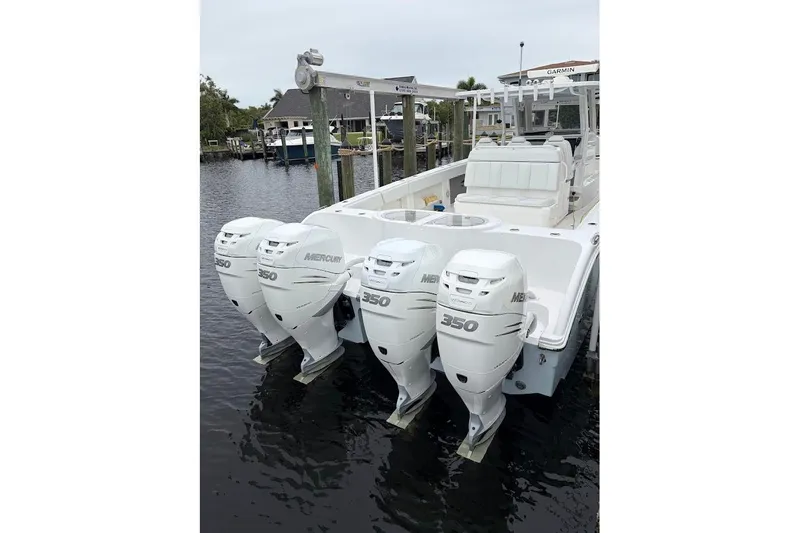 Slide: The Image of 2019 Invincible 40 Catamaran with four Mercury 350 engines docked by the water. - 22