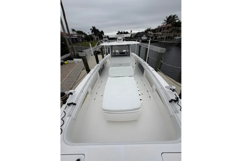 Slide: The Image of 2019 Invincible 40 Catamaran docked, showcasing spacious deck and seating area. - 6