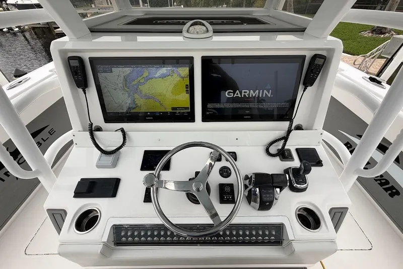 Slide: The Image of 2019 Invincible 40 Catamaran helm with dual Garmin displays and navigation controls. - 8