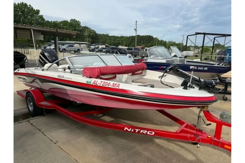 Slide: The Image of 2009 Nitro 189 Sport boat on red trailer, parked at marina. - 4