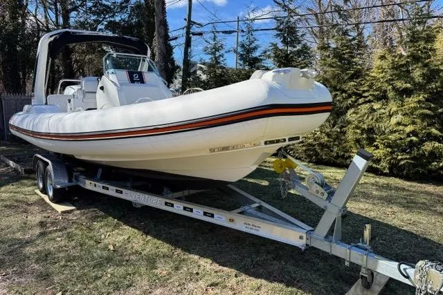 The Image of 2024 Zodiac Medline 7.5 GT boat on trailer, parked outdoors, surrounded by trees. - 0