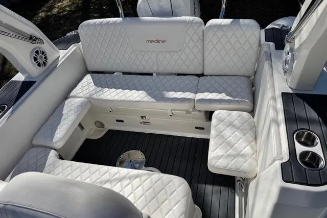 Slide: The Image of 2024 Zodiac Medline 7.5 GT boat interior with white quilted seating and cup holders. - 11