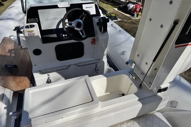 Slide: The Image of 2024 Zodiac Medline 7.5 GT boat cockpit with Garmin navigation system and storage compartments. - 13