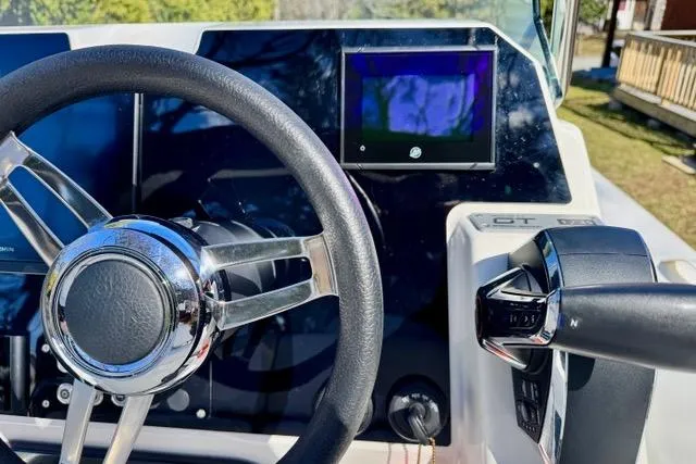 Slide: The Image of Steering wheel and controls of 2024 Zodiac Medline 7.5 GT boat cockpit. - 14
