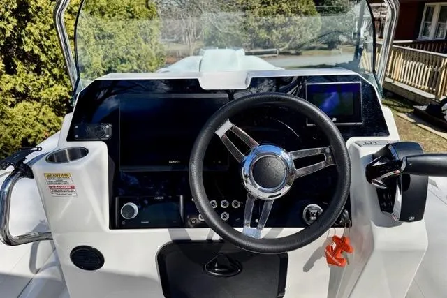 Slide: The Image of 2024 Zodiac Medline 7.5 GT boat dashboard with steering wheel and control panel. - 15