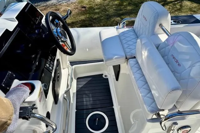 Slide: The Image of 2024 Zodiac Medline 7.5 GT boat interior with white seating and modern steering console. - 16