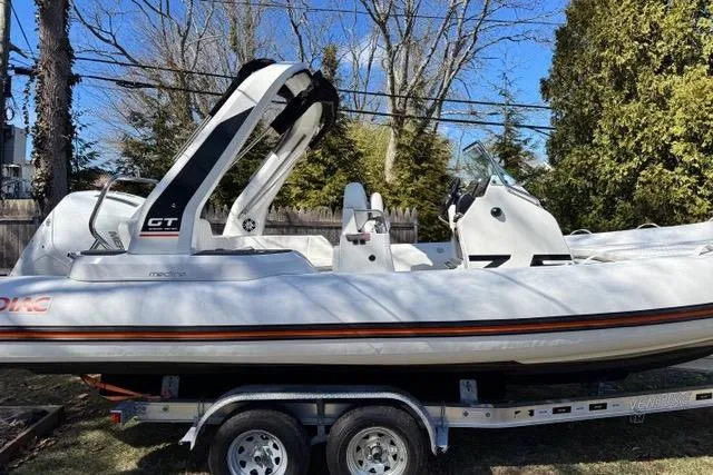 Slide: The Image of 2024 Zodiac Medline 7.5 GT boat on trailer, outdoor setting, side view. - 2