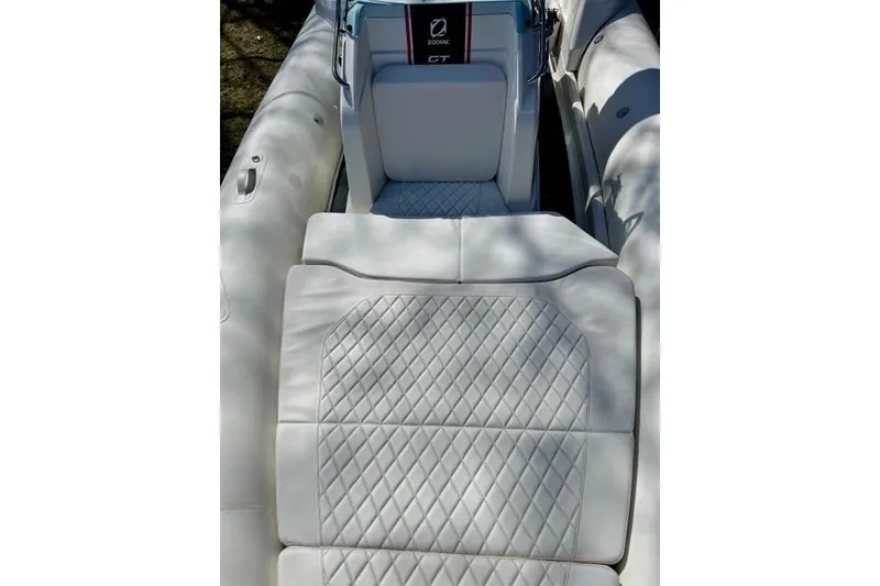 Slide: The Image of 2024 Zodiac Medline 7.5 GT boat interior with luxurious quilted white seating. - 21