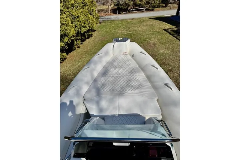 Slide: The Image of 2024 Zodiac Medline 7.5 GT boat with cushioned deck, parked on grass. - 22