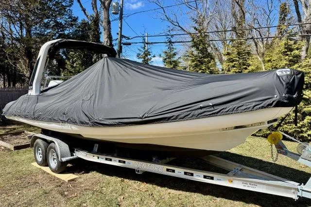 Slide: The Image of 2024 Zodiac Medline 7.5 GT boat covered on trailer, parked outdoors. - 24