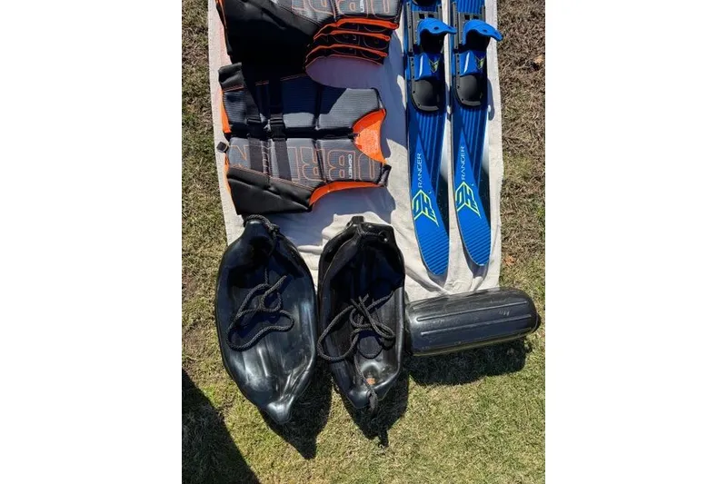 Slide: The Image of Water sports gear including life vests, blue skis, and Zodiac Medline 7.5 GT accessories. - 32
