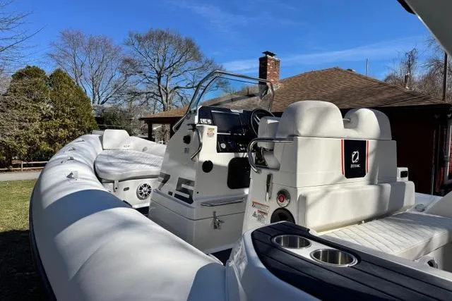 Slide: The Image of 2024 Zodiac Medline 7.5 GT boat with sleek design and modern features, docked outdoors. - 5