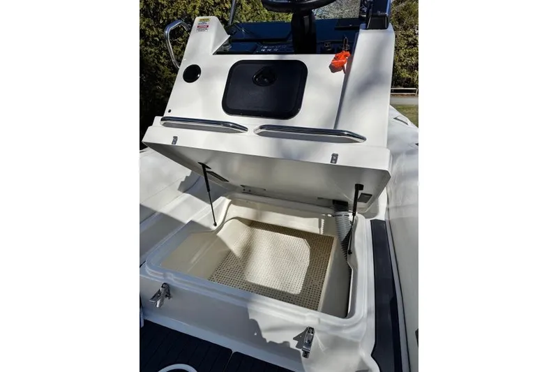 Slide: The Image of 2024 Zodiac Medline 7.5 GT boat storage compartment open, showcasing interior space. - 7
