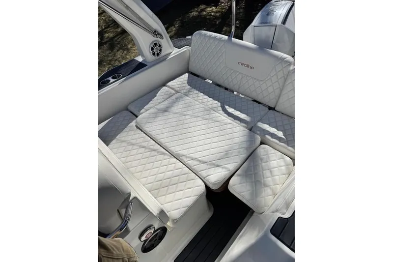 Slide: The Image of Luxurious seating on 2024 Zodiac Medline 7.5 GT boat with quilted white upholstery. - 9