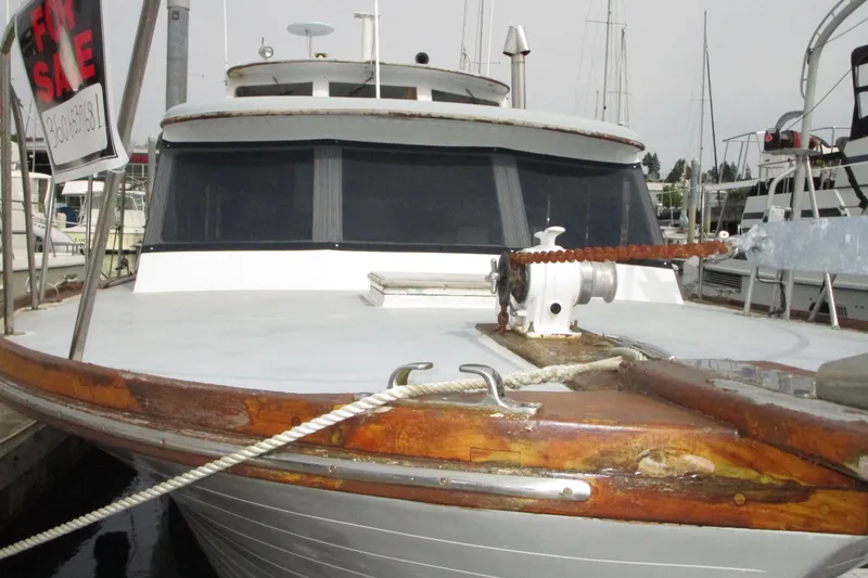 The Image of 1979 Roughwater 41 boat for sale at marina, featuring wooden deck and anchor chain. - 1