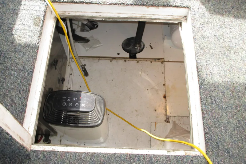 Slide: The Image of Bilge area of 1979 Roughwater 41 boat with dehumidifier and yellow cable. - 12