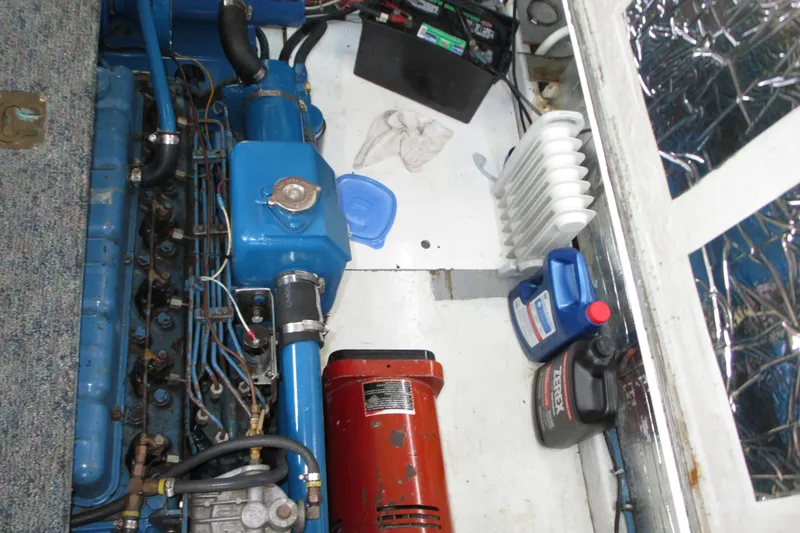Slide: The Image of Engine compartment of a 1979 Roughwater 41 boat with visible components and supplies. - 14