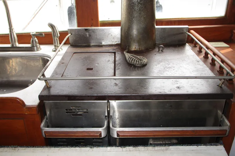 Slide: The Image of 1979 Roughwater 41 boat kitchen with vintage stove and sink setup. - 15