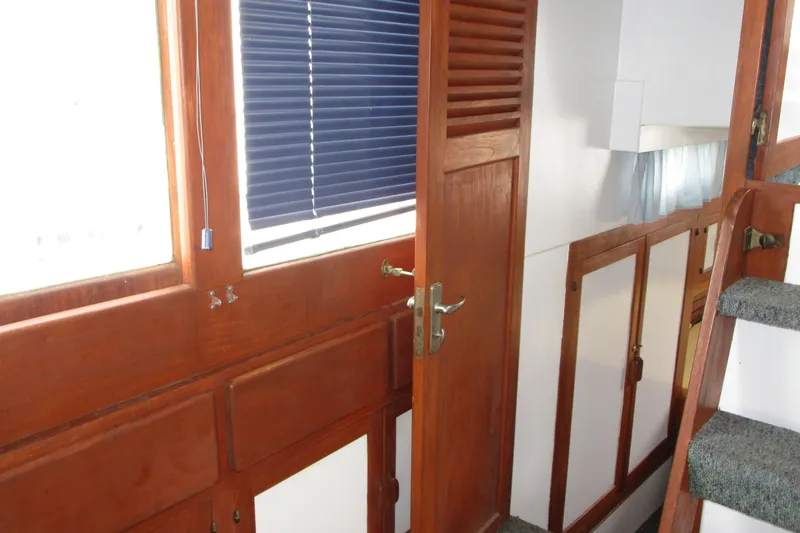 Slide: The Image of Interior of 1979 Roughwater 41 boat with wooden doors and carpeted stairs. - 18