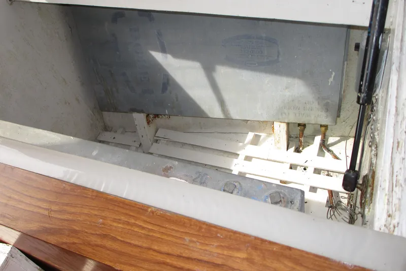Slide: The Image of Interior view of a 1979 Roughwater 41 boat compartment with visible battery and wiring. - 19