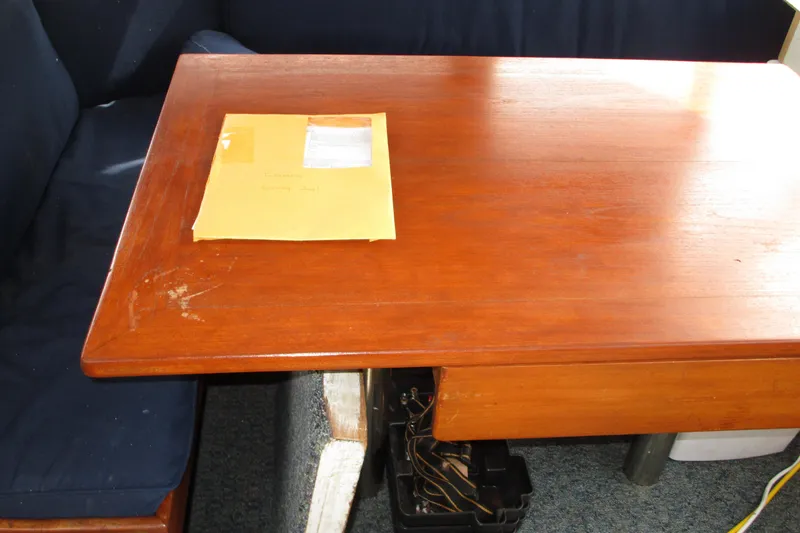 Slide: The Image of Wooden table with an envelope on a Roughwater 41, 1979 model boat interior. - 20