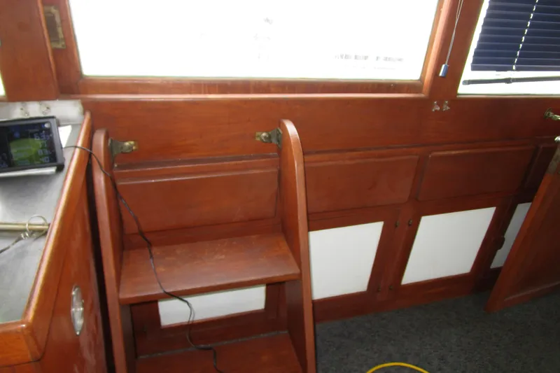 Slide: The Image of Interior of 1979 Roughwater 41 boat with wooden steps and cabinetry. - 23