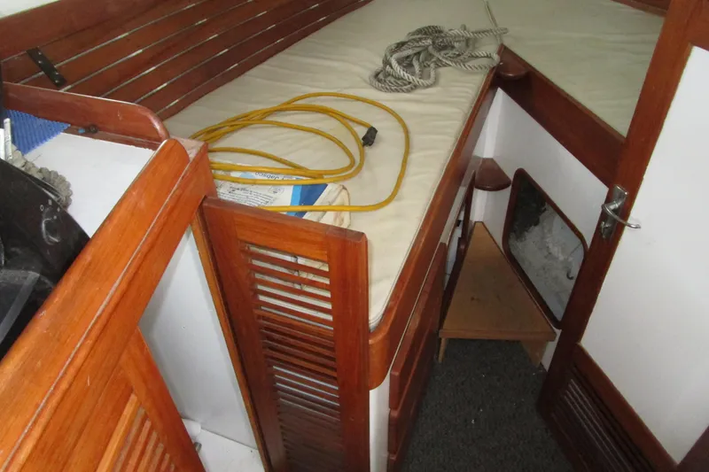 Slide: The Image of 1979 Roughwater 41 boat interior with wooden paneling and storage space. - 24