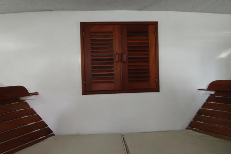 Slide: The Image of Interior of 1979 Roughwater 41 boat with wooden louvered cabinet and seating. - 29