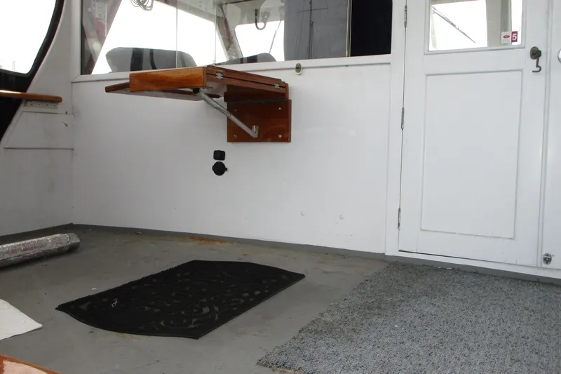 Slide: The Image of Interior of a 1979 Roughwater 41 boat with foldable wooden seat. - 3