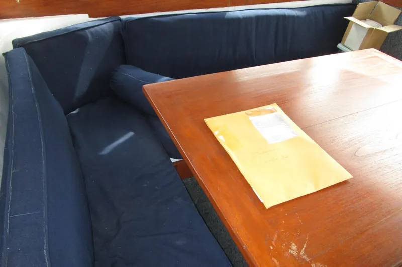 Slide: The Image of Interior of 1979 Roughwater 41 boat with wooden table and blue seating. - 31