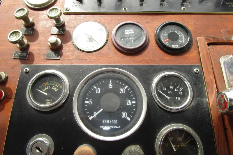 Slide: The Image of 1979 Roughwater 41 boat dashboard with gauges and controls. - 33