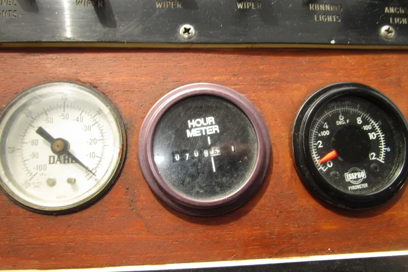 Slide: The Image of Instrument panel of a 1979 Roughwater 41 boat with gauges and hour meter. - 34
