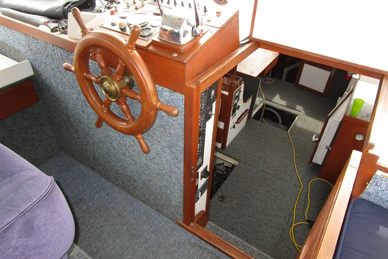Slide: The Image of Interior of 1979 Roughwater 41 boat with wooden steering wheel and control panel. - 35