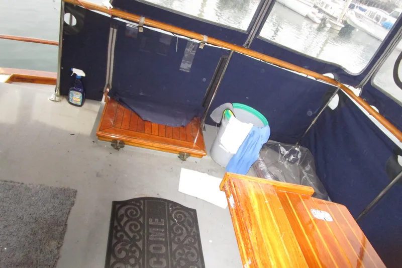 Slide: The Image of Interior of 1979 Roughwater 41 boat with wooden furniture and cleaning supplies. - 36