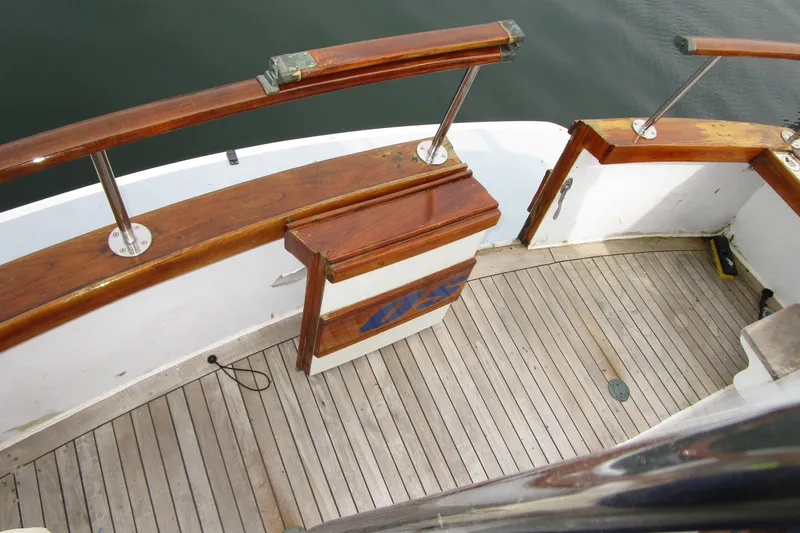 Slide: The Image of 1979 Roughwater 41 boat deck with wooden railings and flooring. - 37