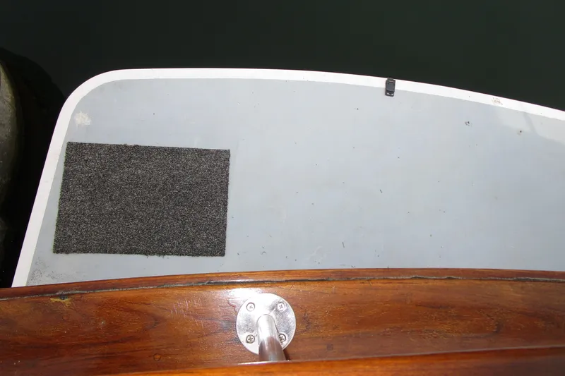 Slide: The Image of 1979 Roughwater 41 boat deck with wooden railing and gray mat. - 38