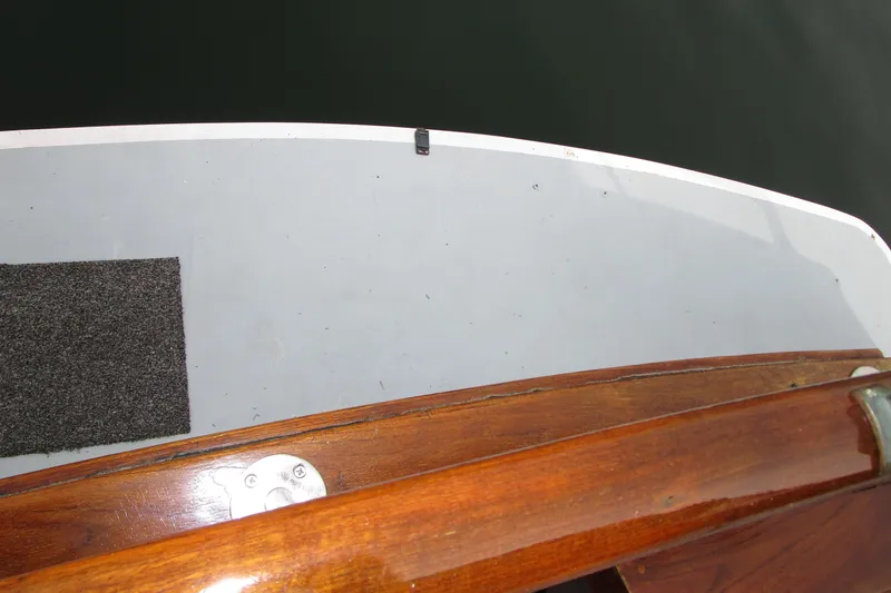 Slide: The Image of 1979 Roughwater 41 boat deck with wooden railing and gray mat. - 39