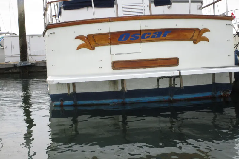 Slide: The Image of Stern view of 1979 Roughwater 41 boat named "Oscar" docked in marina. - 42