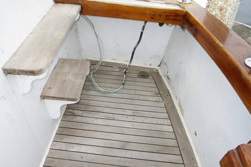 Slide: The Image of 1979 Roughwater 41 boat interior with wooden steps and deck, featuring visible wiring. - 5